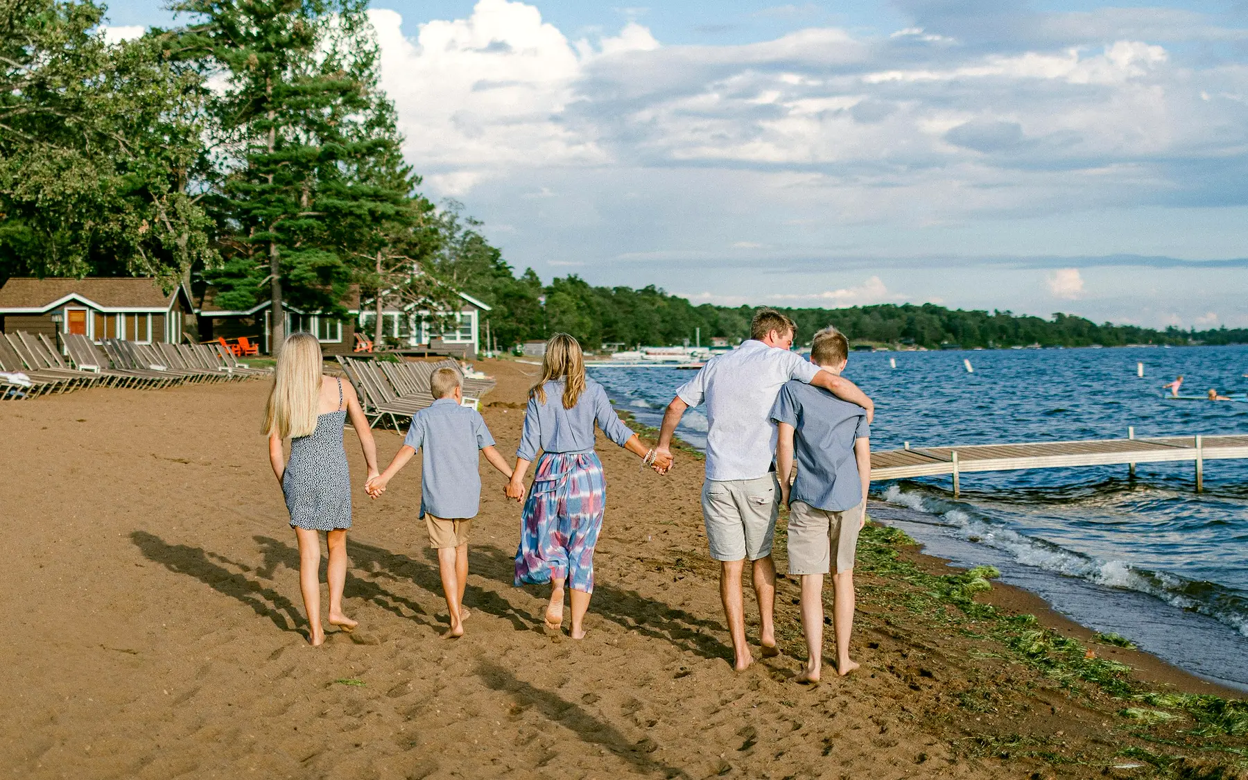 A family walking together beside the water