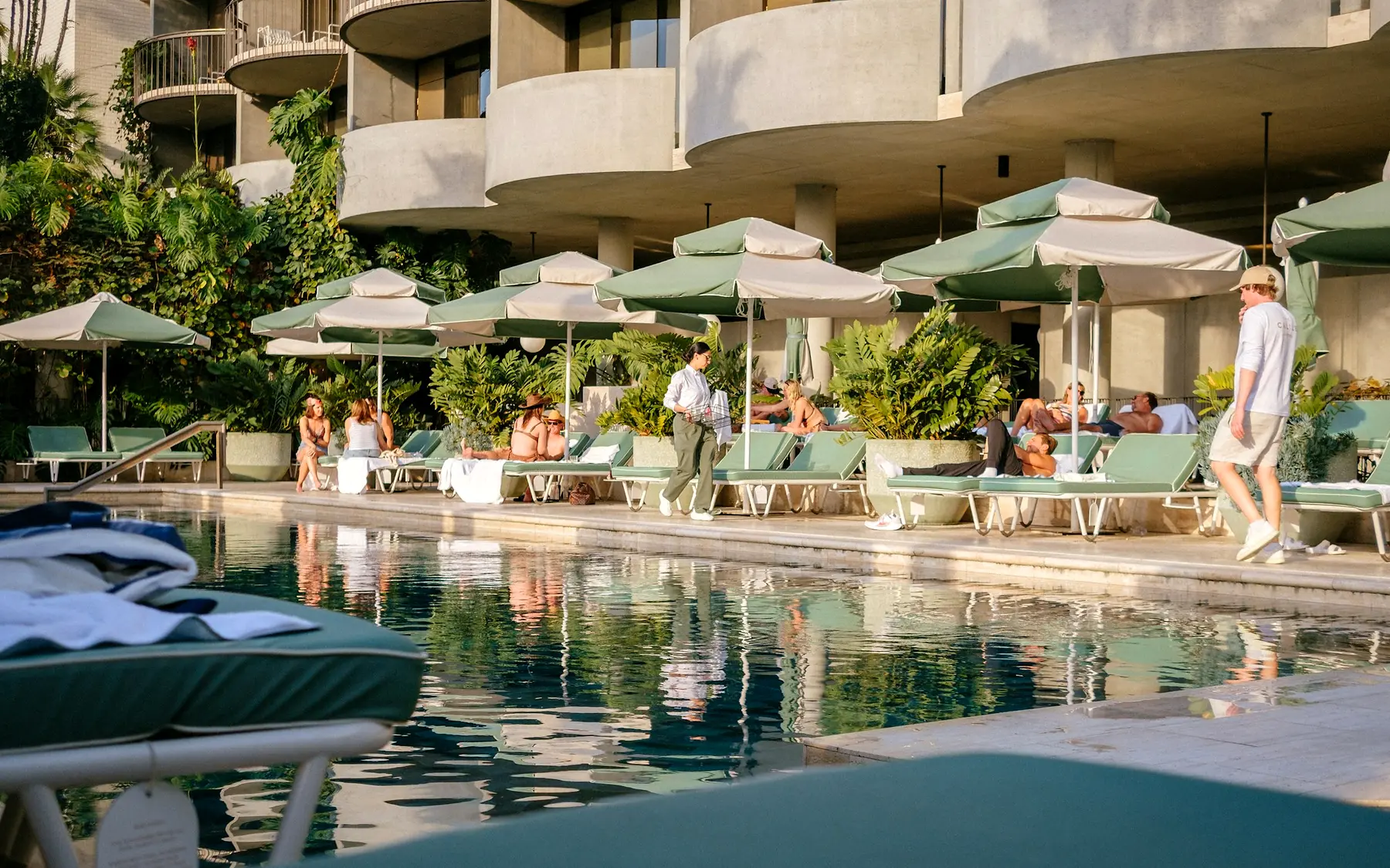 Travellers relaxing beside a hotel pool